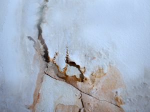 Cracks and water damage in wall