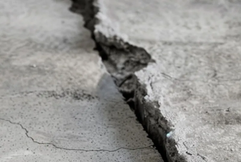 Photo of sunken, uneven concrete of basement floor