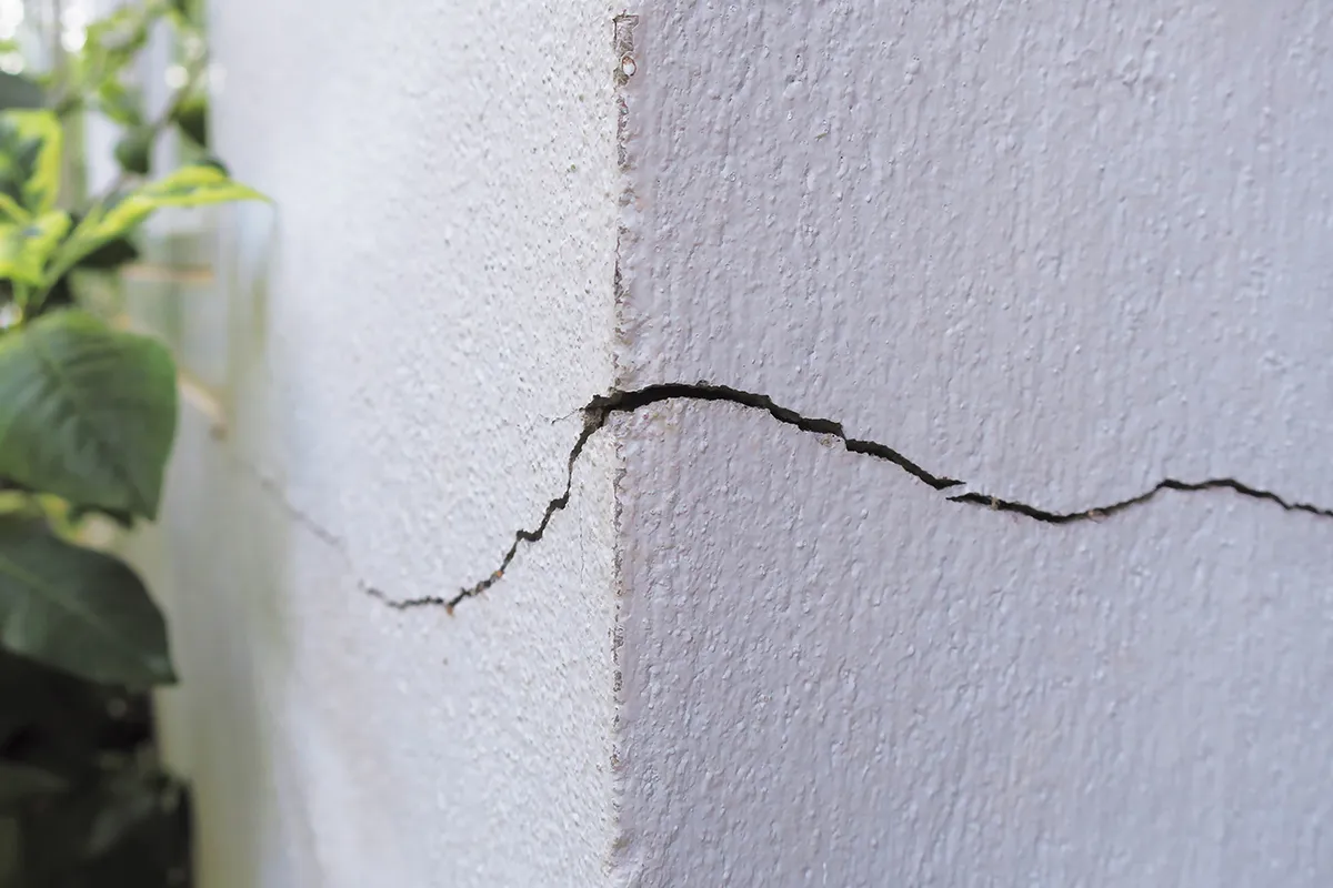 Photo of cracks in a wall to show needs for interior basement waterproofing