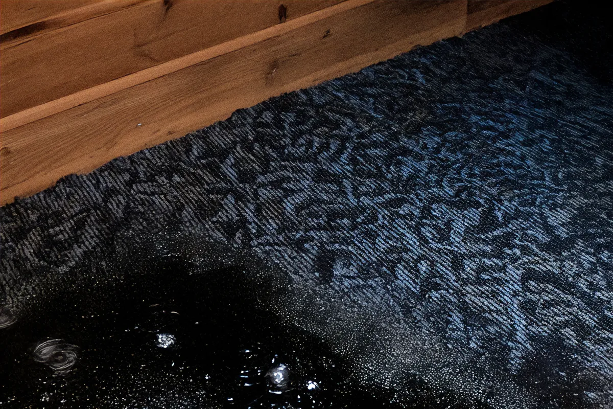 Blue basement carpet with wet water stains